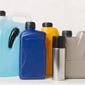 Plastic containers and spray can on table.